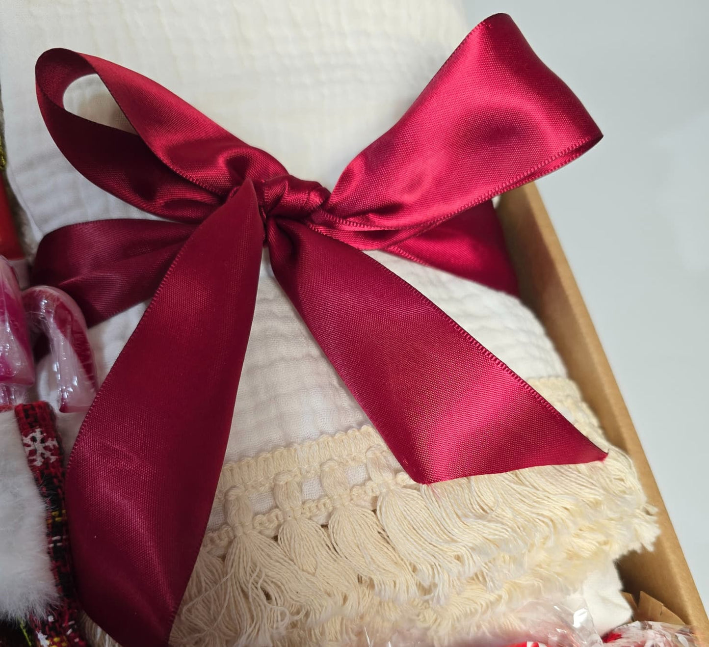 Magical Christmas gift box featuring a Nutcracker figure, gold snowflake mug, Christmas Magic reed diffuser, cozy fringed blanket, and Lindor chocolates.