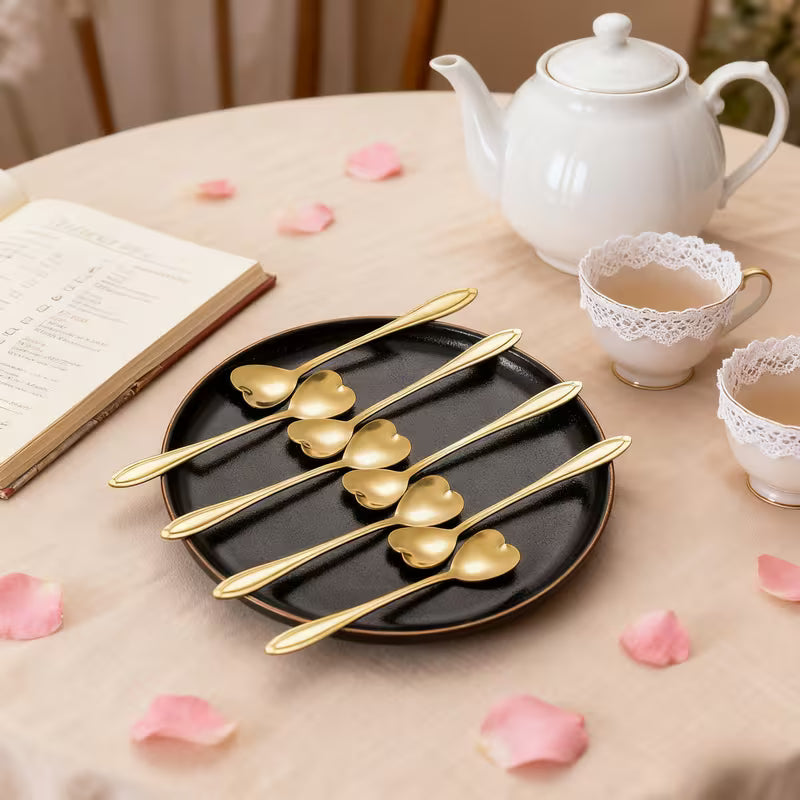 Luxury gold coffee spoon with polished modern design placed on a neutral background.