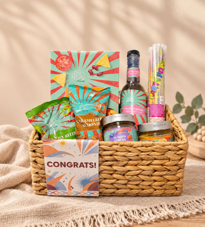 Congratulations gift basket by Gifting CY with Food Festival treats, party poppers and a congrats card