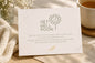 Get well soon card with a flower illustration on a wooden surface with a cup and flowers.