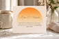 Motivational card with 'Rise & Smile' text on a table with decor items