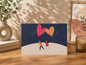 Greeting card with 'Good Vibes' text and heart-shaped balloons on a wooden surface.