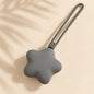 Grey star-shaped silicone case with long loop strap on a warm beige boho-minimal background.