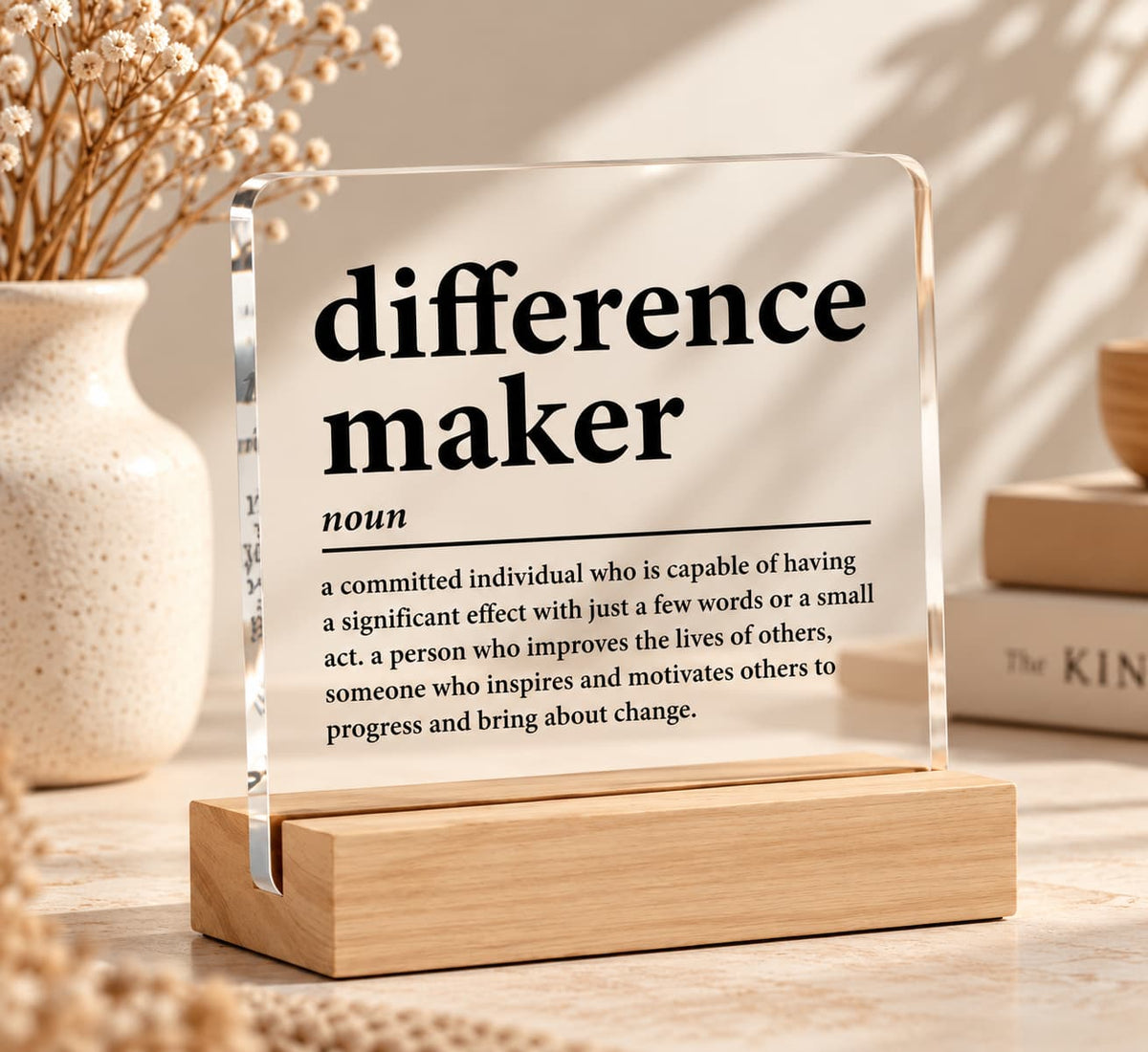 Difference Maker clear acrylic desk sign with black dictionary-style inspirational quote and natural wooden base, a thoughtful teacher or mentor appreciation gift.