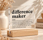 Difference Maker clear acrylic desk sign with black dictionary-style inspirational quote and natural wooden base, a thoughtful teacher or mentor appreciation gift.
