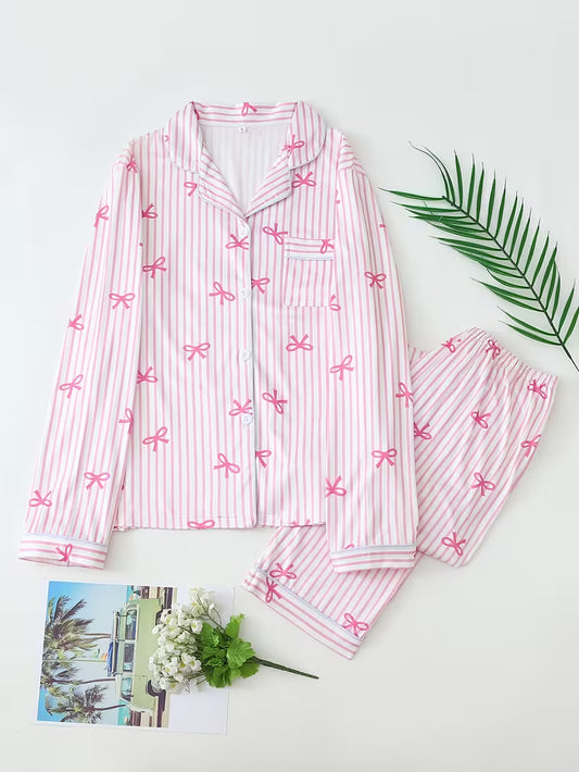 Cute 2-piece pajama set with elegant pink bow prints displayed beautifully for cozy sleepwear, feminine loungewear, and luxury self-care gifting.