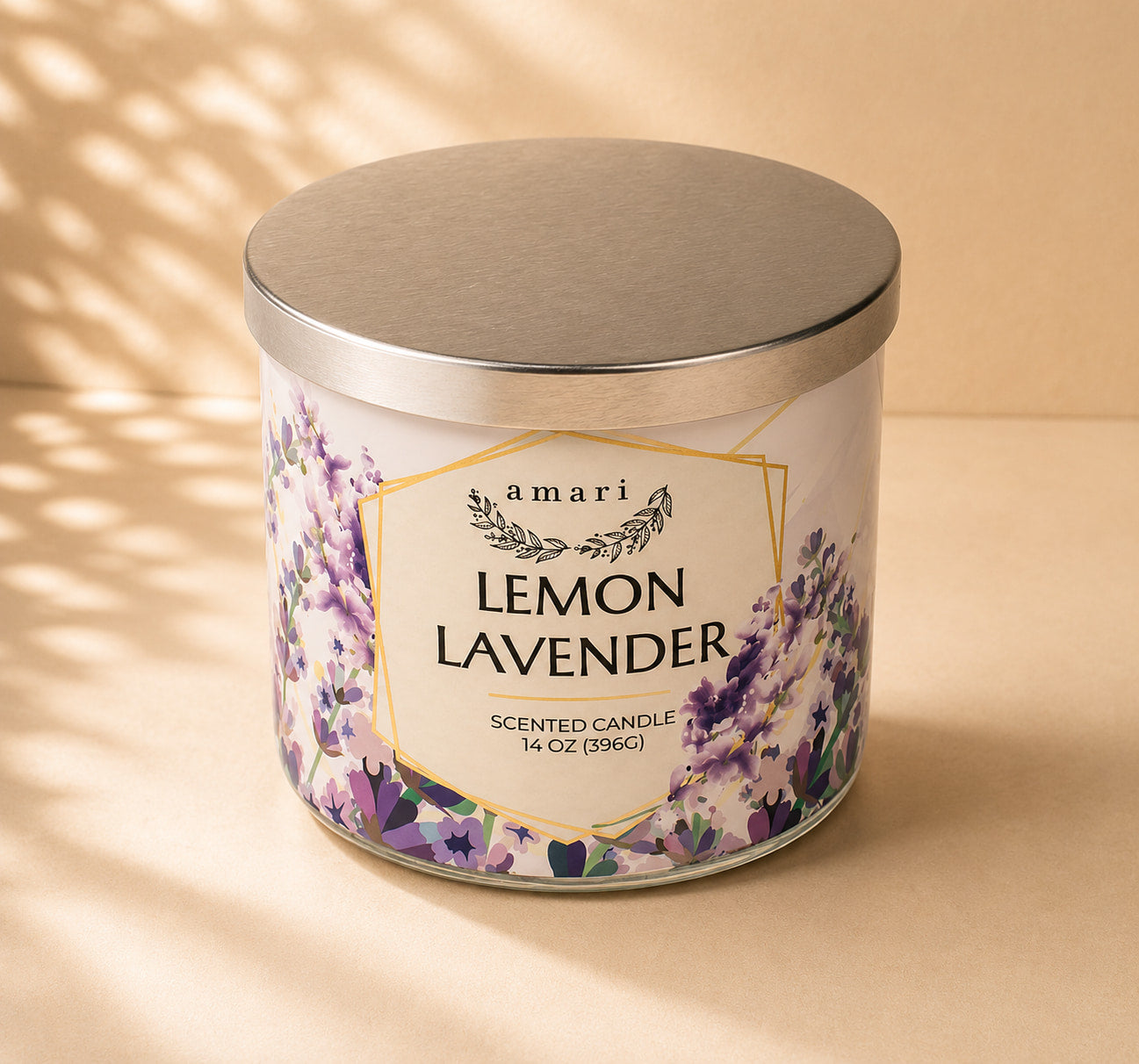 A 14 oz scented candle in a white glass jar with a brushed silver metal lid. The label features purple lavender flowers and gold geometric borders, with the text 'amari LEMON LAVENDER'.
