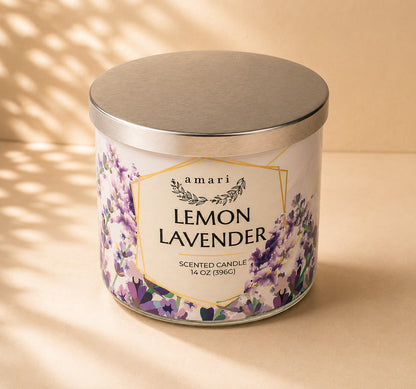 A 14 oz scented candle in a white glass jar with a brushed silver metal lid. The label features purple lavender flowers and gold geometric borders, with the text 'amari LEMON LAVENDER'.