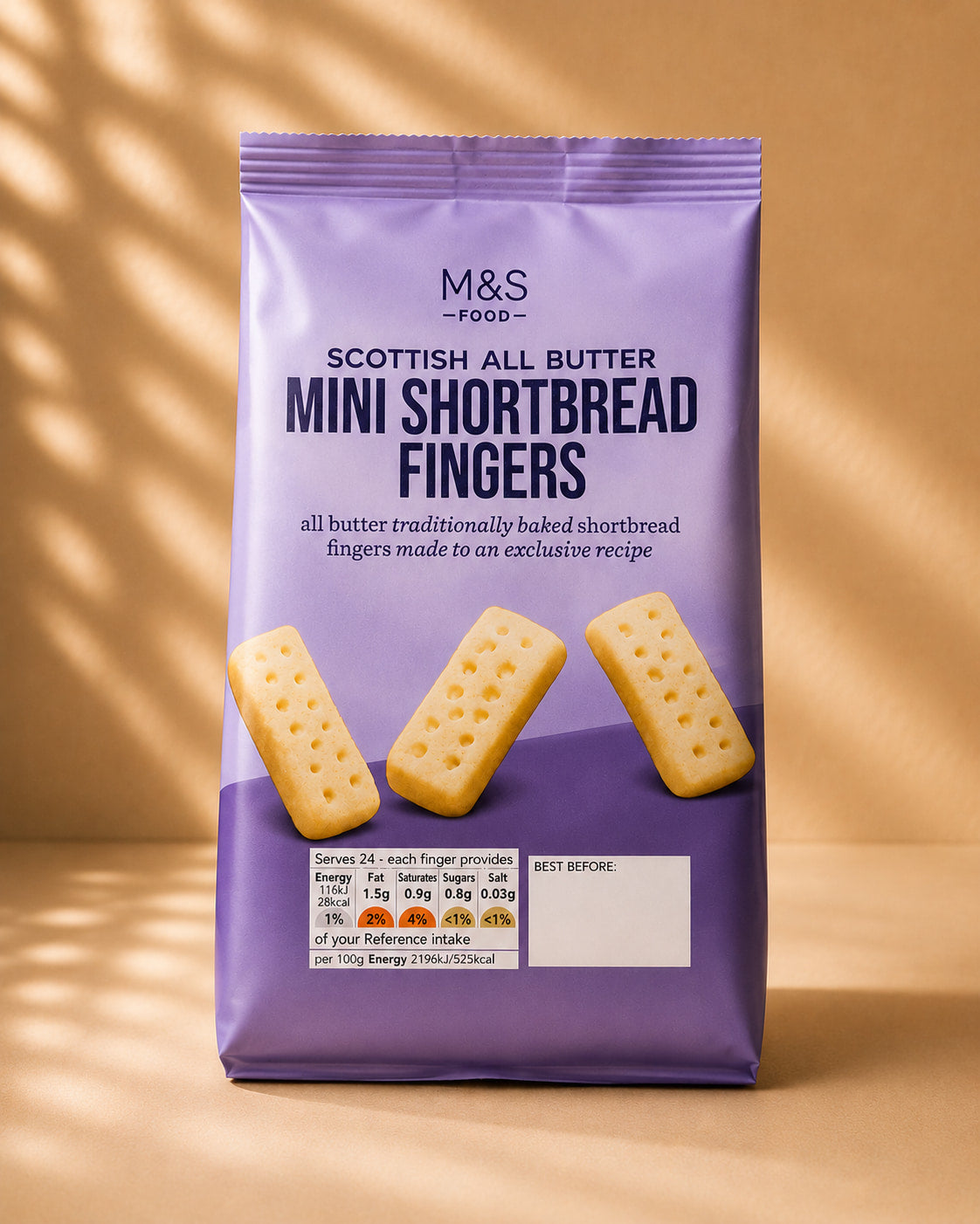 A purple bag of M&S Scottish All Butter Mini Shortbread Fingers on a warm beige background with soft diagonal shadows. The packaging features three golden-brown mini shortbread fingers and product details.