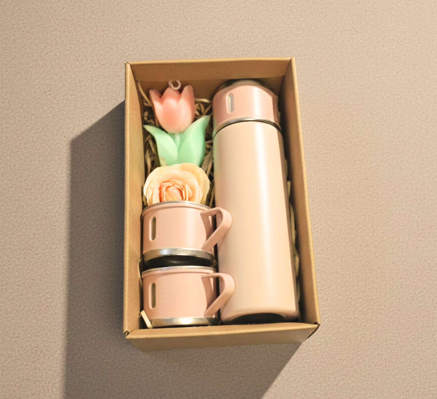 Pink insulated thermos gift set featuring two stackable travel cups, a tulip accent, and a rose accessory, all packed in a kraft box.