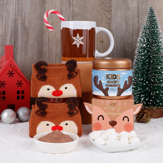 Kids Christmas hot chocolate gift set with reindeer socks, snowflake mug, hot chocolate mix, and marshmallows.
