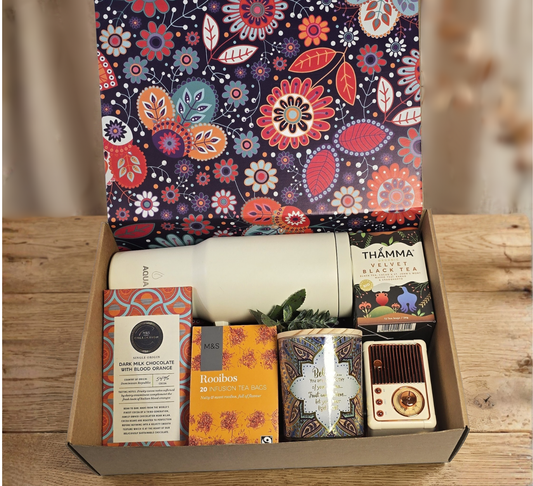 Psychedelic Mandala Gourmet Gift Box featuring M&S Rooibos and Dark Chocolate with Blood Orange, Thamma Black Tea, an insulated water bottle, decorative candle, and retro speaker.