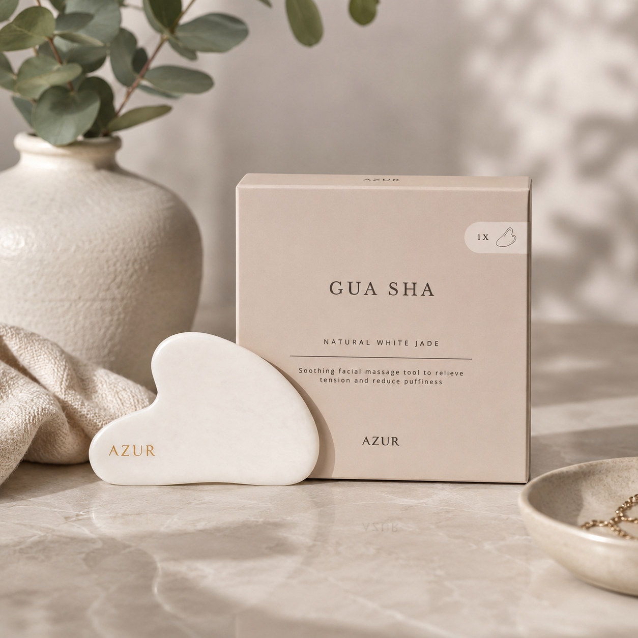 Azur Natural White Jade Gua Sha facial massage tool with elegant packaging displayed on a neutral spa-inspired background for skincare and self-care.