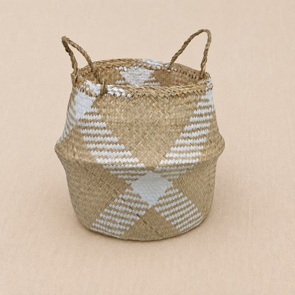 A woven natural baby fiber basket with two loop handles, featuring a geometric white and light beige pattern on a neutral beige background.