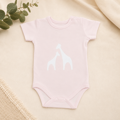 Mokkiry cotton baby bodysuit with giraffe print, available in pink and blue, size 3–6 months.