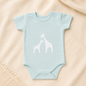 Mokkiry cotton baby bodysuit with giraffe print, available in pink and blue, size 3–6 months.