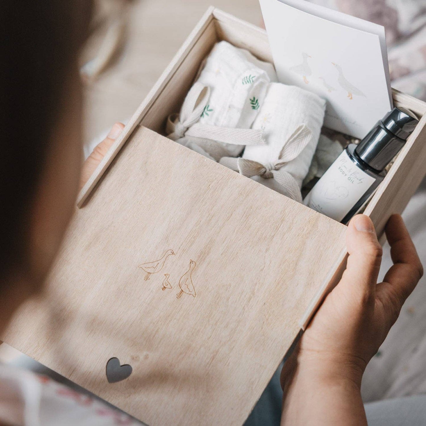 Wooden Geese baby memory box with delicate goose motif and heart-shaped detail, designed for storing newborn and childhood keepsakes.