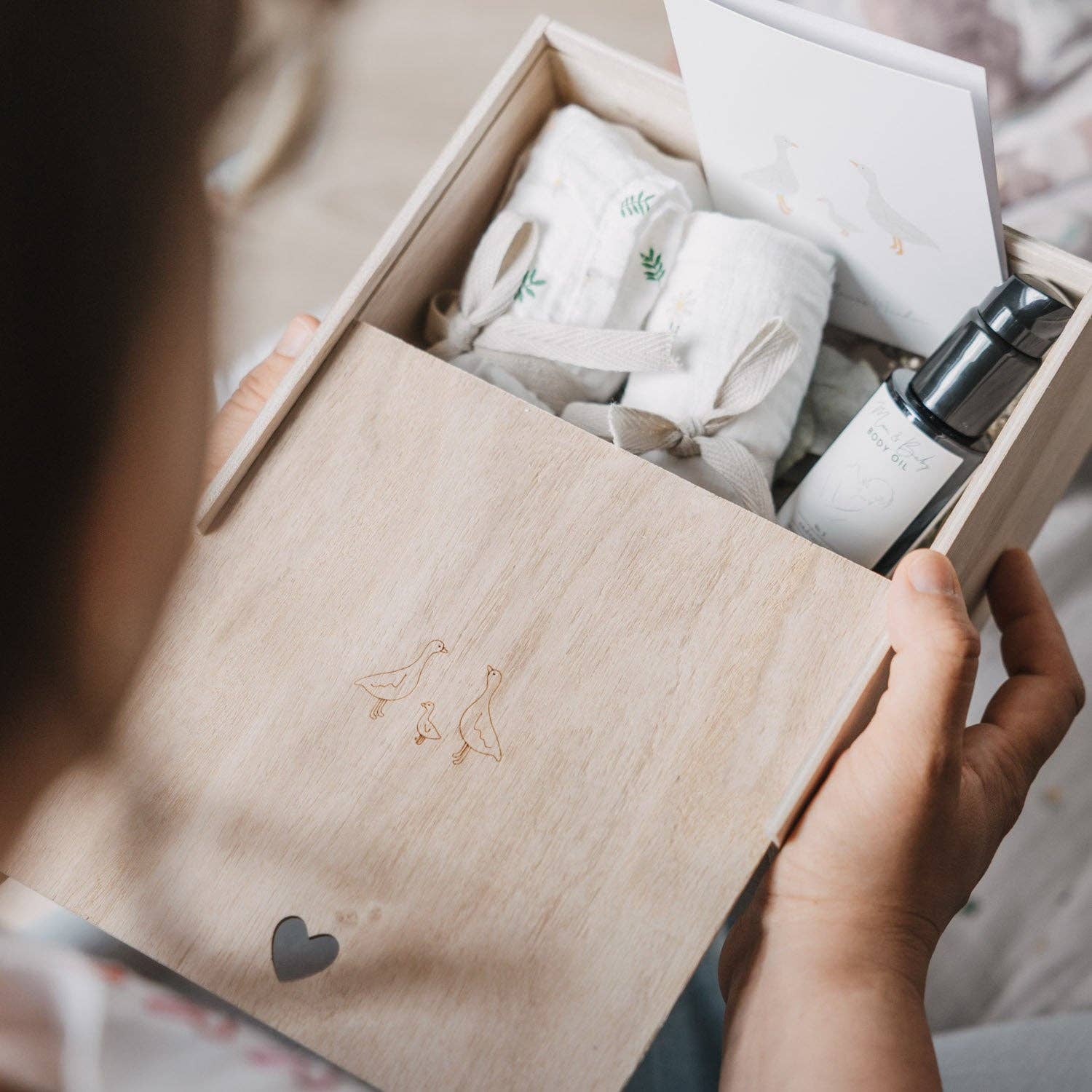 Wooden Geese baby memory box with delicate goose motif and heart-shaped detail, designed for storing newborn and childhood keepsakes.