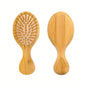 Eco-friendly bamboo wooden hair brush with natural wooden bristles displayed on a neutral background.