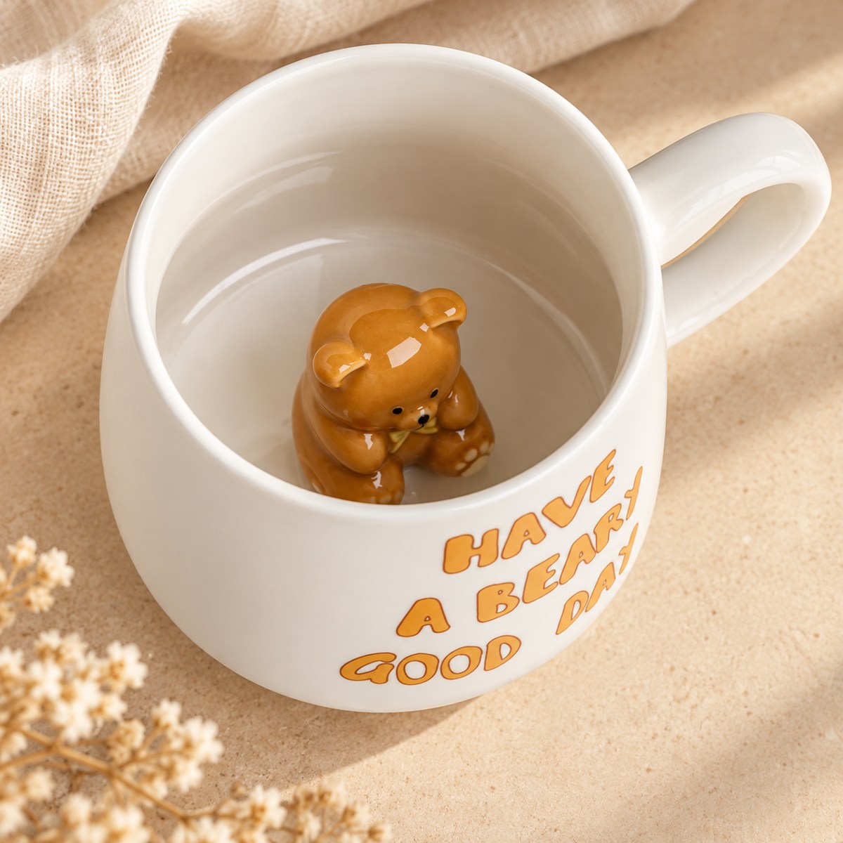 View inside the white ceramic mug showing a small brown 3D teddy bear at the bottom.