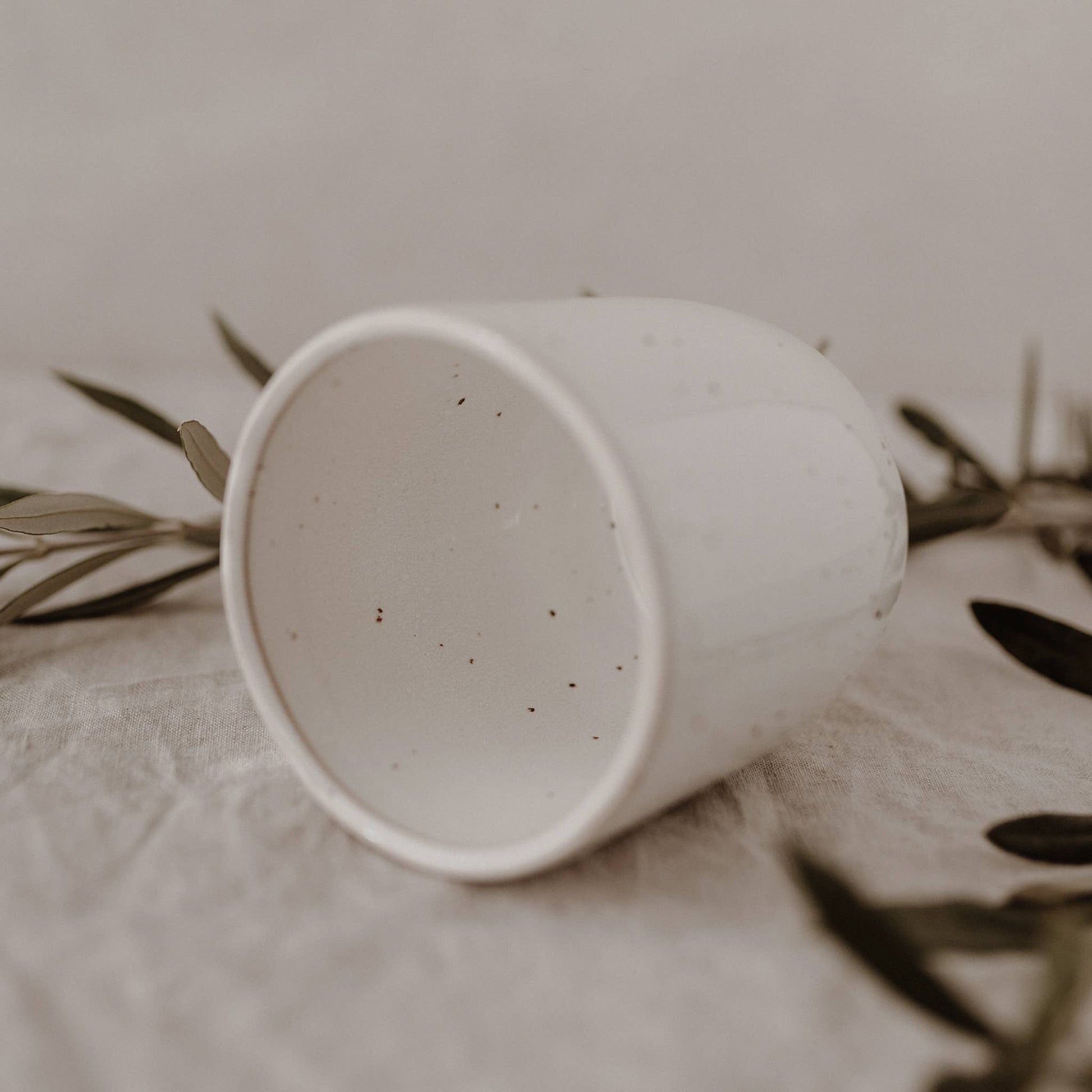 Calma handmade earthenware mug with natural glaze and minimalist design, handcrafted in Portugal with a 320ml capacity.