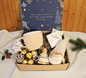 Enchanted Christmas gift box featuring a snow globe, cozy knitted mug, festive gnome, Ferrero Rocher chocolates, and gourmet marshmallows.
