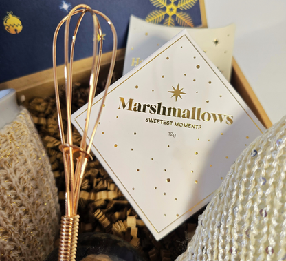 Enchanted Christmas gift box featuring a snow globe, cozy knitted mug, festive gnome, Ferrero Rocher chocolates, and gourmet marshmallows.