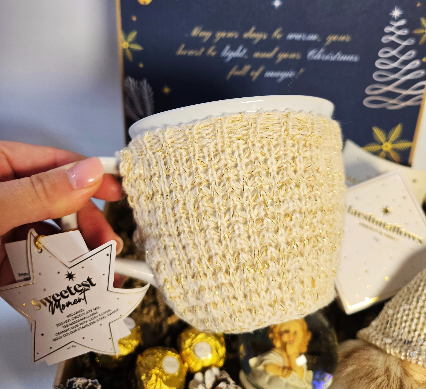 Enchanted Christmas gift box featuring a snow globe, cozy knitted mug, festive gnome, Ferrero Rocher chocolates, and gourmet marshmallows.