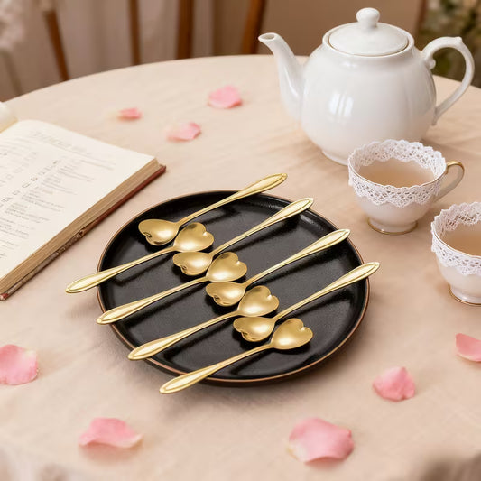 Luxury gold coffee spoon with polished modern design placed on a neutral background.