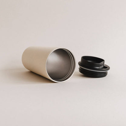 Cream heart travel cup with its black lid removed, showing the metal interior.