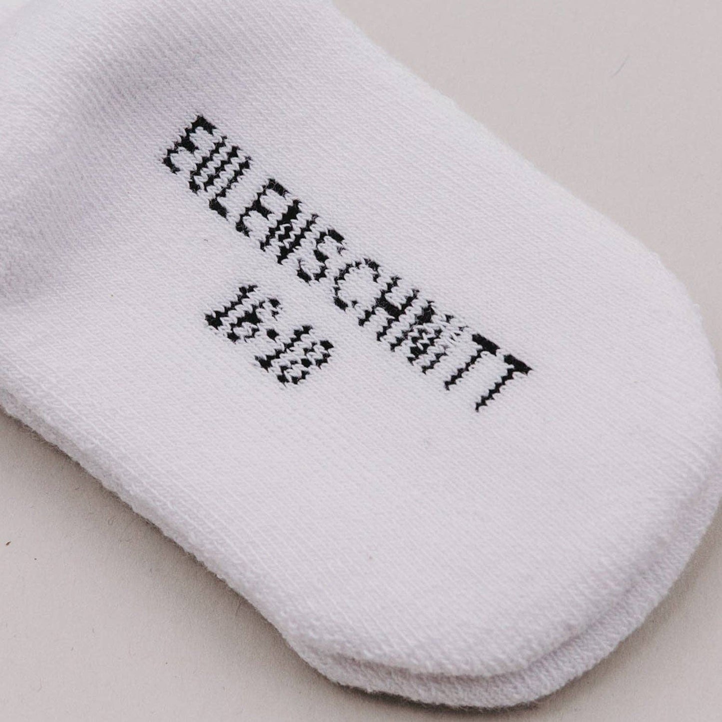 Soft Mini baby socks with minimalist lettering for newborns and sensitive baby skin.
