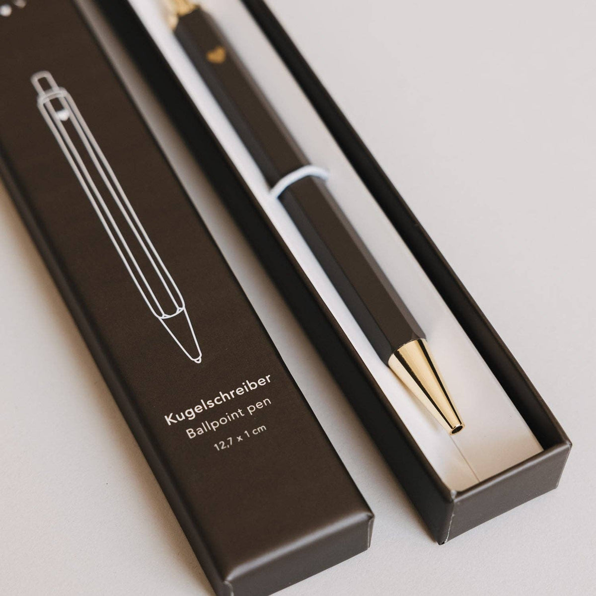 Close-up of the brown Eulenschnitt ballpoint pen and gold-tone tip inside its presentation box.