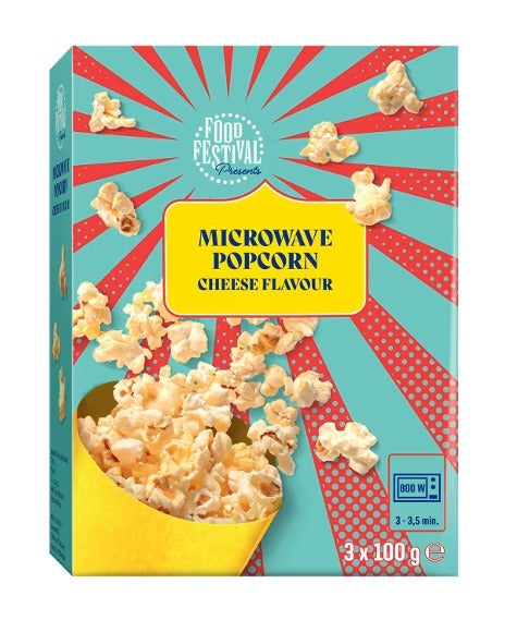 A box of Microwave Popcorn Cheese Flavour, featuring a retro design with red sunburst rays on a teal background, a yellow popcorn bucket filled with popcorn, and a 'Food Festival Presents' logo.