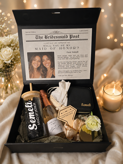 Luxury personalized Maid of Honor proposal gift box featuring a custom tumbler, mini sparkling wine bottle, personalized accessories, rose, and heartfelt proposal card inside a black keepsake box with the name .