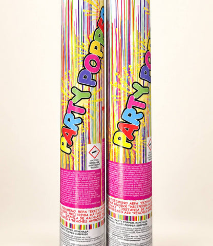 Two colorful 'Party Popper' party popper canisters standing upright against a plain off-white background.