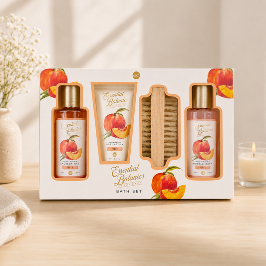 Essential Botanics Peach Bath Gift Set featuring nourishing shower gel, body lotion, bubble bath, and body brush in elegant botanical gift packaging displayed on a soft neutral background.