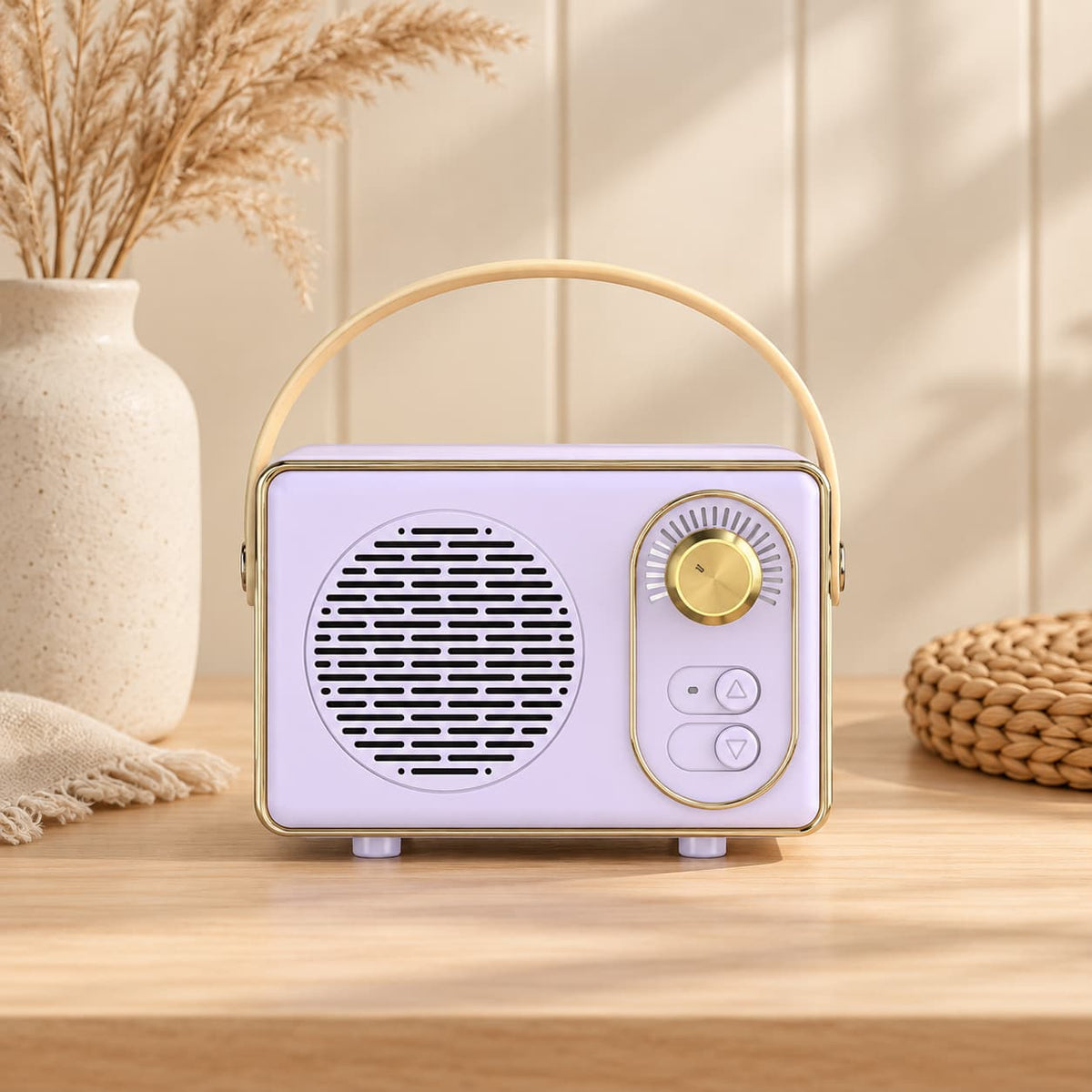 Retro portable speaker with gold-tone dial and carry handle, available in cream, sage green, blush pink and lilac.