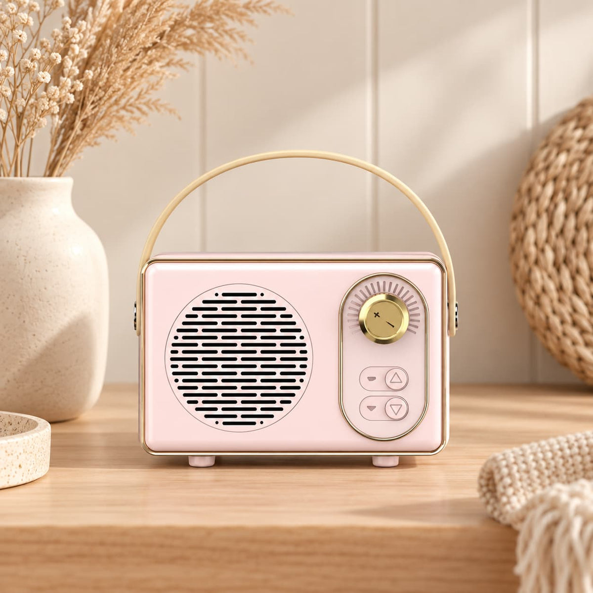 Retro portable speaker with gold-tone dial and carry handle, available in cream, sage green, blush pink and lilac.