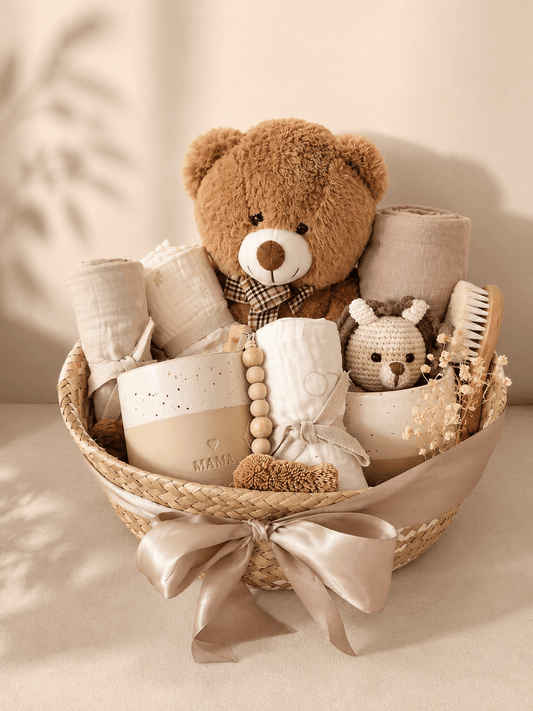 boho baby gift basket with brown teddy bear, muslin, ceramic  keepsakes, brush, crochet toy, dried flowers and ribbon.