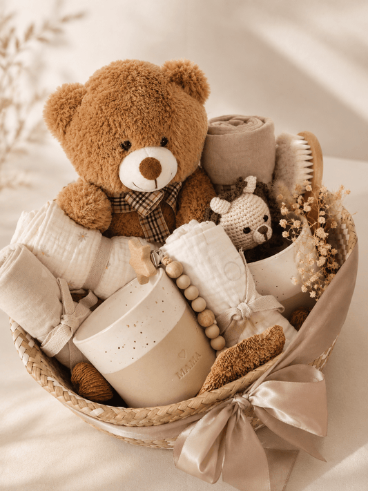 boho baby gift basket with brown teddy bear, muslin, ceramic  keepsakes, brush, crochet toy, dried flowers and ribbon.