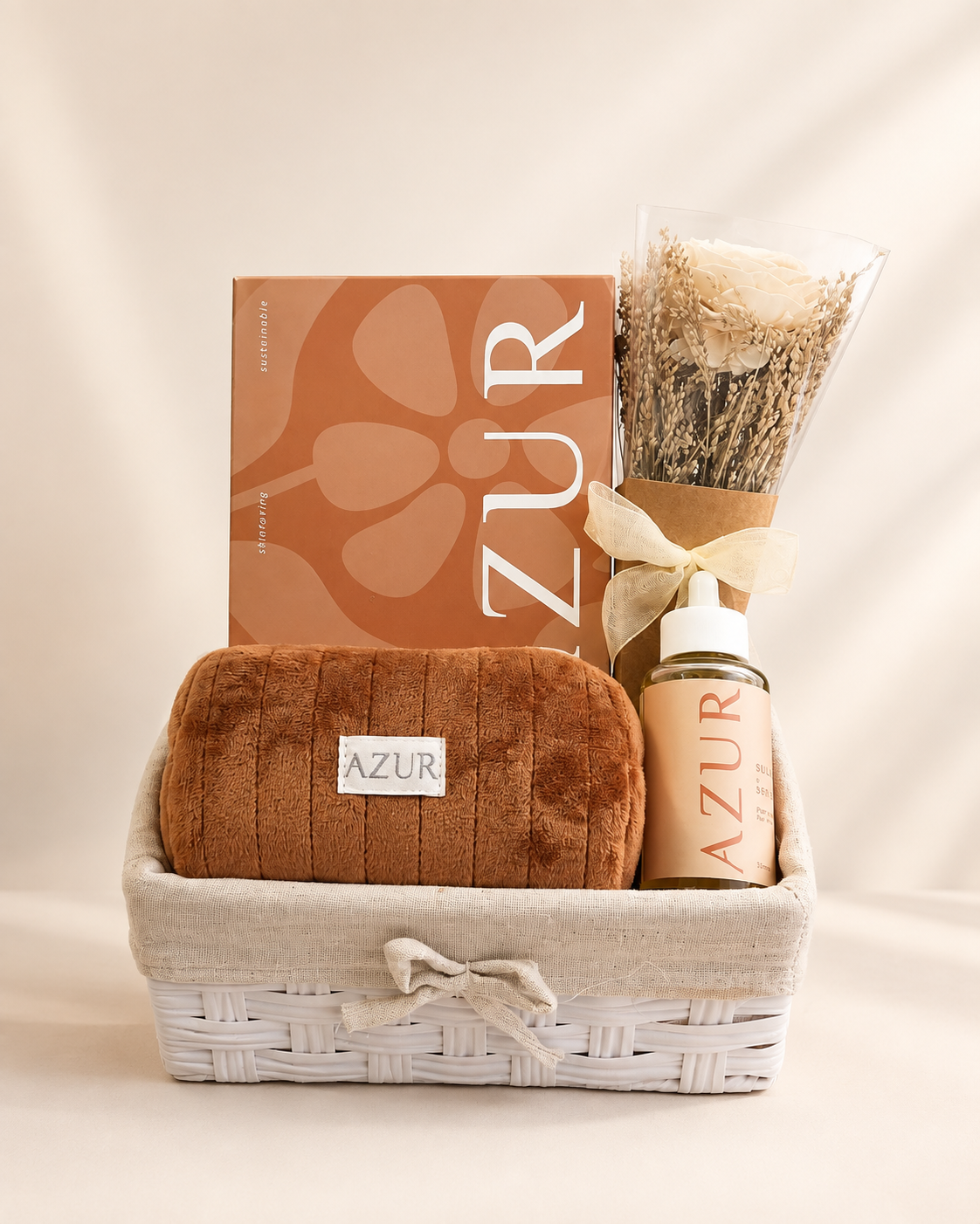 AZUR self-care gift basket with hair oil, spa box, makeup pouch and artificial flower arrangement in an elegant reusable basket.