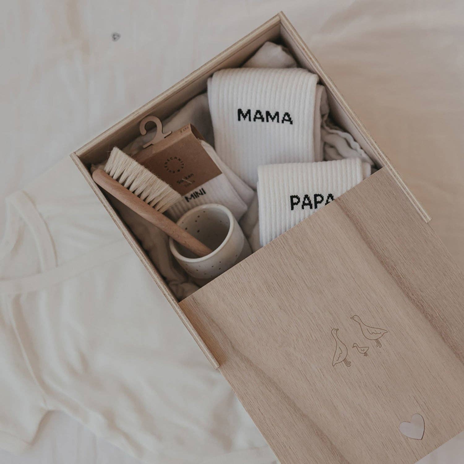 Wooden Geese baby memory box with delicate goose motif and heart-shaped detail, designed for storing newborn and childhood keepsakes.